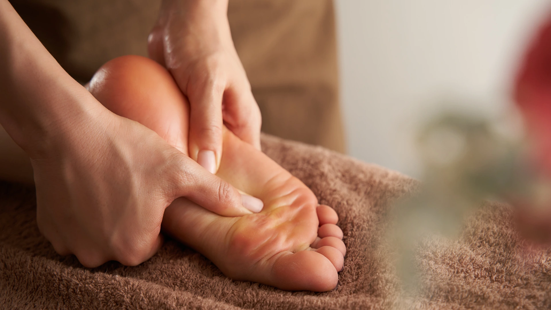 Therapist giving feet massage to client